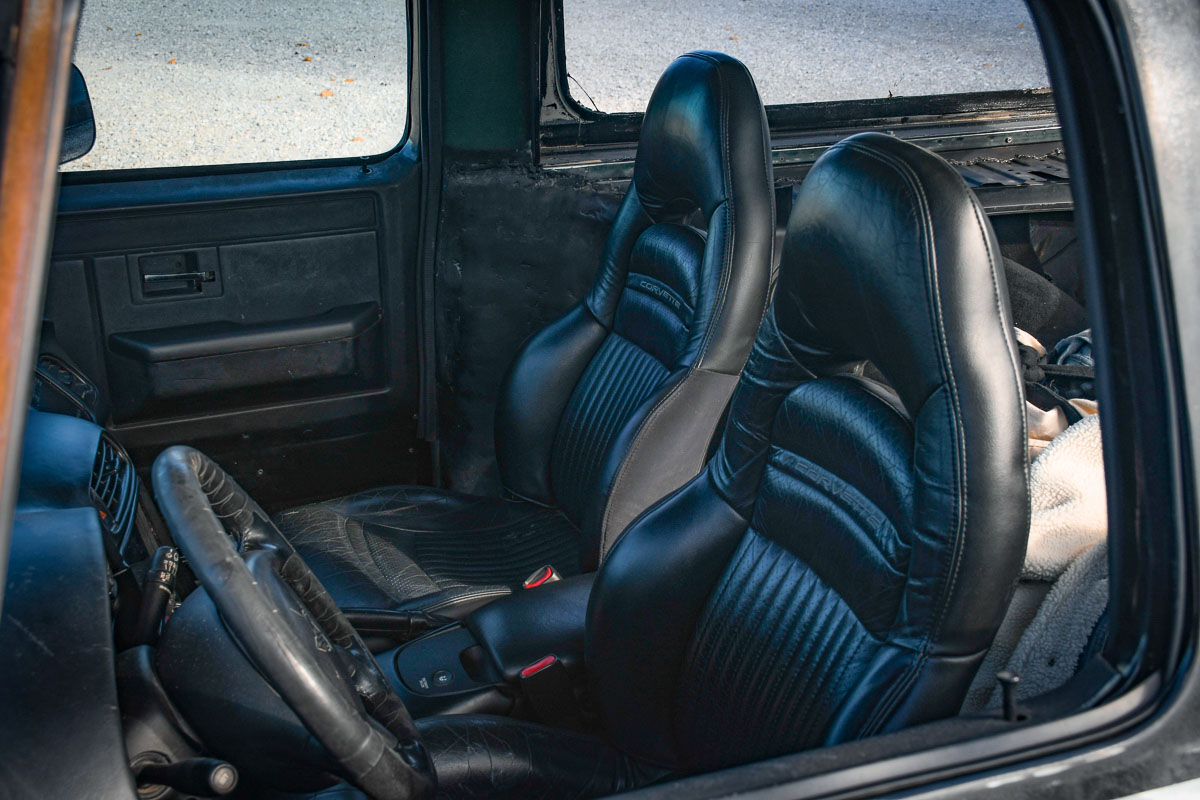 Interior shot of the Blahvette, featuring stock black leather seats and classic instrumentation.