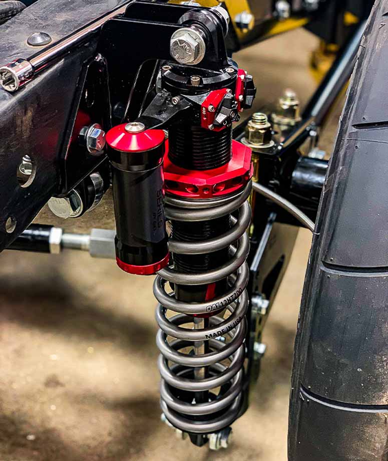 High-performance QA1 shocks with 4-way adjustability, allowing drivers to independently control compression and rebound settings for better handling.