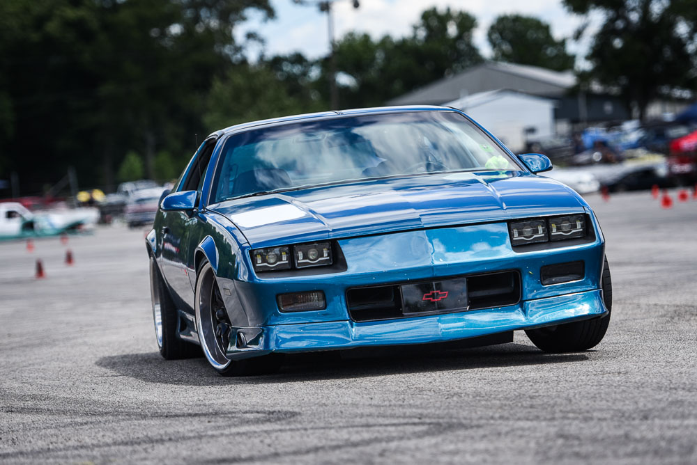 A third camaro f body cornering on an autocross course.